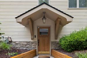 a front door of a house with awning at The Coyote by Juniper Holiday + Home in Saugatuck +38 photos