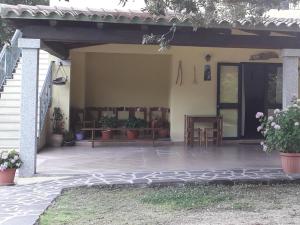 a patio of a house with potted plants at Agriturismo La Tuva in Padru +21 photos