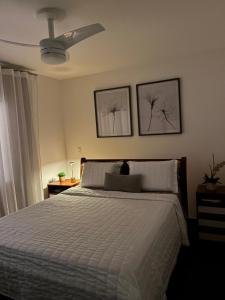 a bedroom with a bed and two pictures on the wall at Casa Au Clair de Lune Terê in Teresópolis +13 photos