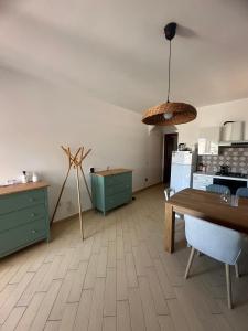 a room with a kitchen with a table and a windmill at Hilltop Apartment in Castelsardo