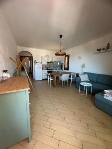 a living room with a blue couch and a table at Hilltop Apartment in Castelsardo +14 photos