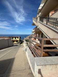 a balcony of a building with a view of the ocean at Hilltop Apartment in Castelsardo
