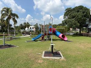 a playground with a slide in a park at Landed IOI City Mall Country Heights Putrajaya Homestay in Kajang