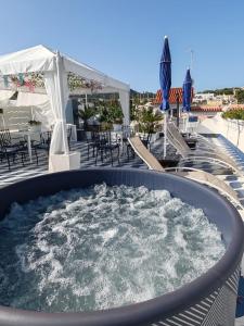 a hot tub on the deck of a resort at Blu D Alia Exclusive Rooms in Ischia Town