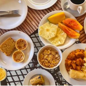 a bunch of plates of food on a table at Hotel Palmanova in Maceió
