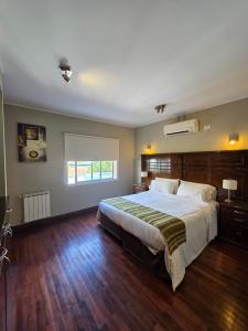 a bedroom with a large bed and a window at Caseros Salta in Salta +101 photos