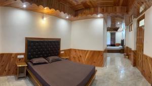 a bedroom with a bed in a room with wooden floors at The Pine View in Kasol