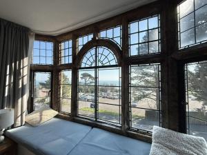 a room with a large window with a couch at 4 Coram Tower in Lyme Regis