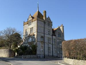an old stone building on the side of a street at 4 Coram Tower in Lyme Regis