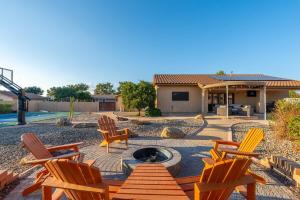 a patio with chairs and a fire pit in a yard at Glendale Paradise - Pool - Pickleball - Putt-Putt in Glendale