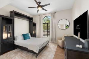 a bedroom with a bed and a ceiling fan at Glendale Paradise - Pool - Pickleball - Putt-Putt in Glendale +73 photos