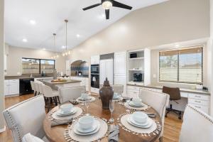 a kitchen and dining room with a table and chairs at Glendale Paradise - Pool - Pickleball - Putt-Putt in Glendale