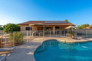 a fence around a swimming pool in front of a house at Glendale Paradise - Pool - Pickleball - Putt-Putt in Glendale