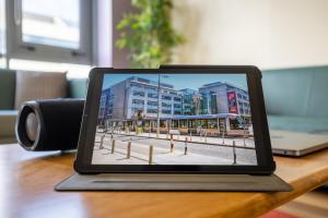 a laptop computer sitting on top of a wooden desk at Canvas Mayor Square in Dublin