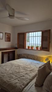 a bedroom with a large bed and two windows at Mi Casa 4 in Jávea