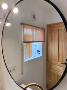 a mirror in a bathroom with a sink and a window at Mi Casa 4 in Jávea +50 photos