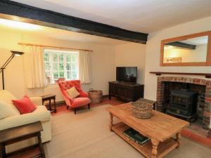 a living room with a couch and a fireplace at Plush Cottage in Dorchester