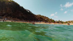 a group of people in the water at a beach at Mariposa - Casa Corazon Mazunte in Mazunte
