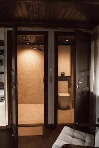 a bathroom with a toilet and a glass door at Supsi Saun in Supsi +5 photos
