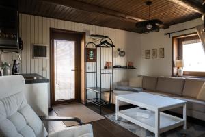 a living room with a couch and a table at Supsi Saun in Supsi