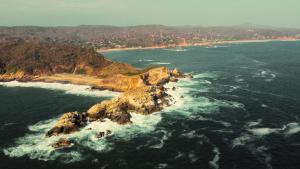 an aerial view of an island in the ocean at Mariposa - Casa Corazon Mazunte in Mazunte