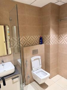 a bathroom with a toilet and a sink at Town Centers in Ghaziabad