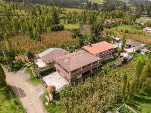 an aerial view of a house in a field at Watzara Wasi Studios en Cotacachi in Cotacachi