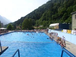 a large swimming pool with a bunch of people in it at Studio Jesenice in Jesenice