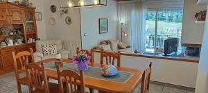 a kitchen and living room with a table and chairs at Torre de l'Olivera in Mediona