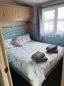 a bedroom with a bed with towels on it at Cocos haven in Ballantrae