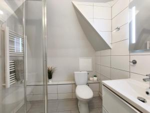 a white bathroom with a toilet and a shower at Mistral Studio in Cassis