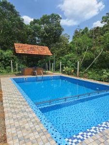 a swimming pool in front of a gazebo at Private Pool Villa Vagamon in Vagamon