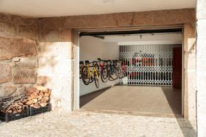 a garage with a bunch of bikes on the wall at Casa Das Flores in Amares