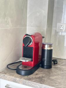 a red toaster sitting on top of a counter at Mamour Apartments in Mavrovouni in Mavrovouni