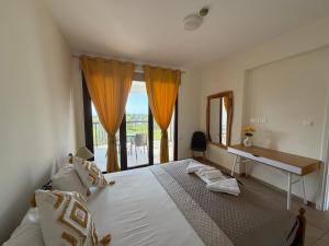 a bedroom with a bed with a desk and a window at Daniel's Hotel Apartments in Paphos +99 photos