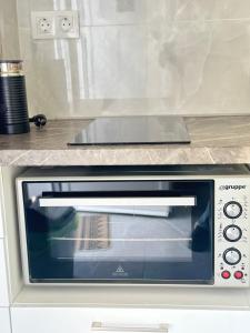 a toaster oven sitting under a counter at Mamour Apartments in Mavrovouni in Mavrovouni