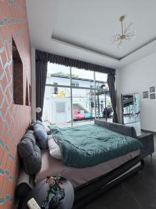 a bedroom with a large bed and a large window at The Lion King Villa in Ban Na +17 photos