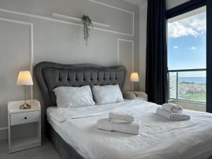 a bedroom with a large bed with towels on it at Caesar Blue Collection Nothern Cyprus whith Bedroom Residences in Ayios Dhometios +121 photos