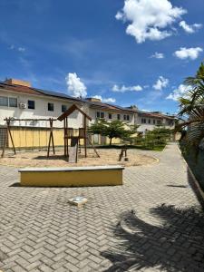 a park with a playground with a swing at Apartamento Cond Leão Dourado 01 in Caruaru