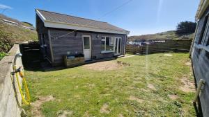 a small house in a yard next to a fence at 3 The Burrows in Braunton