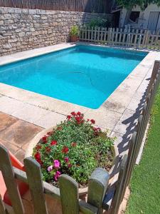a swimming pool with a planter with flowers next to it at Torre de l'Olivera in Mediona