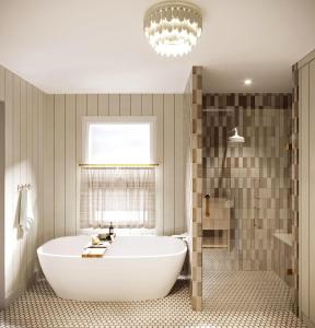 a bathroom with a large tub and a window at Townie 1 - The Ivy by Juniper Holiday + Home in Union Pier