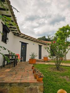 a house with a brick walkway in the yard at Hotel Montelux in Villa de Leyva +54 photos