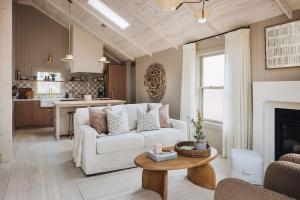 a living room with a white couch and a table at Townie 1 - The Ivy by Juniper Holiday + Home in Union Pier +39 photos