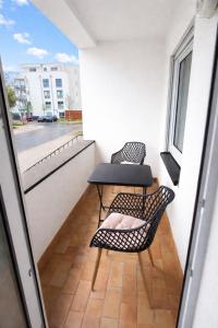a small balcony with two chairs and a table at Comfort Stay Koblenz in Koblenz