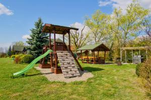 a playground with a slide and a gazebo at Casa de vacanta ROUA DIMINETII in Beclean