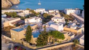 an aerial view of a city with trees and buildings at Sabbia Calda Apartments in Perissa