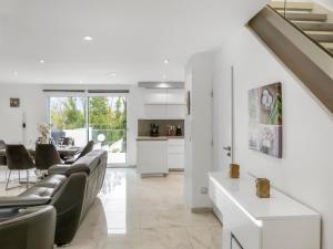 a living room with a couch and a table at Grande villa T6 avec piscine à 30 min de Disneyland Paris in Coulommiers