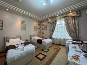a bedroom with two beds and a window at Узбечка in Tashkent +125 photos