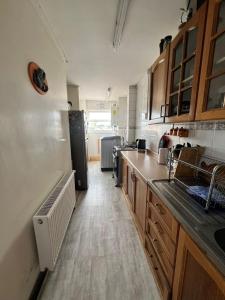 a kitchen with a sink and a refrigerator at DEPARTAMENTO aV BULNES in Punta Arenas